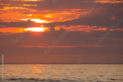 sunset on Unstad beach surrounded by mountains in Lofoten in Norway