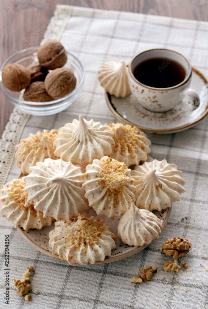 meringues with nuts and cup of coffee meringues with nuts and cup of coffee