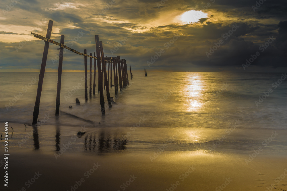 Fototapeta premium Beautiful sunset with old wooden bridge at Khao Pilai in Phang- Nga Province, Thailand