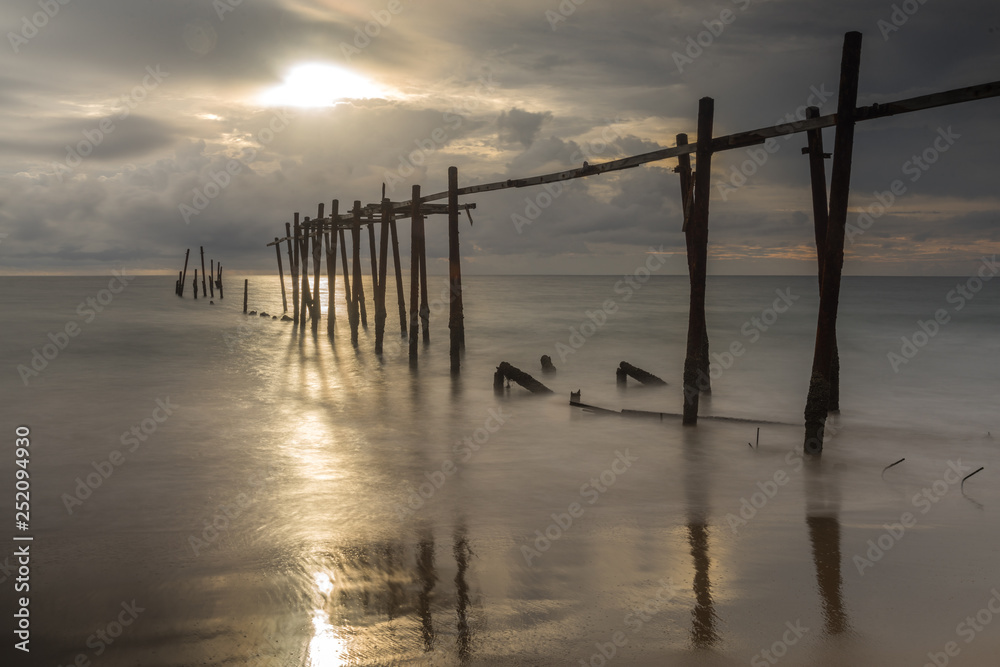 Beautiful sunset with old wooden bridge at Khao Pilai in Phang- Nga Province, Thailand
