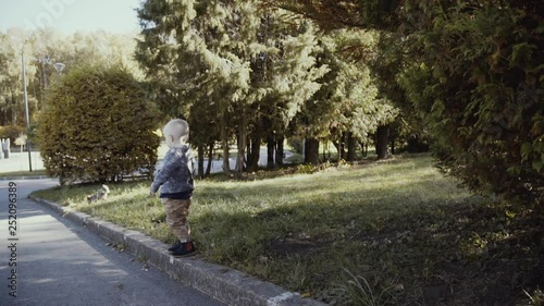 Wallpaper Mural Little male kid walks along the kerb and drops Torontodigital.ca
