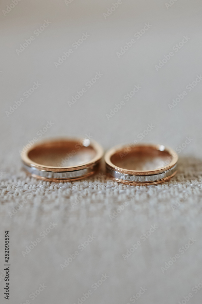 Close up view of stylish gold wedding rings on the textile Close up view of stylish gold wedding rings on the textile