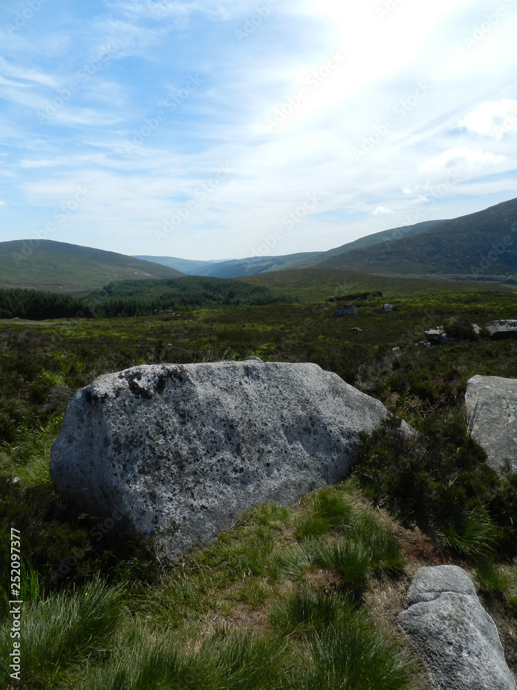 Wicklow Mountains in Ireland with large rocks in foreground Wicklow Mountains in Ireland with large rocks in foreground