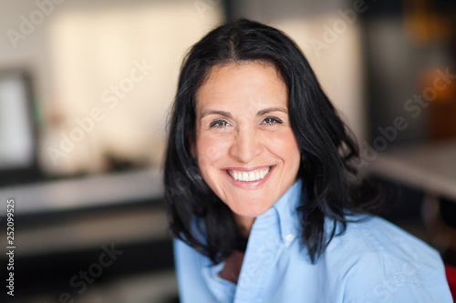 Portrait Of A Mature Spanish woman Smiling At The Camera. At The home