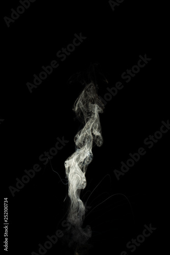 Vape steam column with spray boiling liquid. Stock photo isolated on black background.