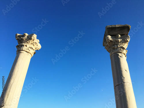 Ancient Roman time town in Crimea. Archeology antique columns on blue sky background photo