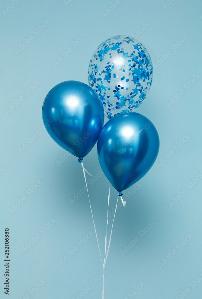 bright matte balloons on a blue background. three blue inflated balloons. stylish party with balloons. round blue and transparent balloon. place of celebration bright matte balloons on a blue background. three blue inflated balloons. stylish party with balloons. round blue and transparent balloon. place of celebration