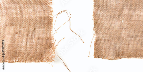 Clean sackcloth fabric worn edges, detail closeup on white background.