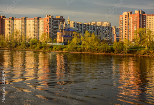 View of the residential area of St. Petersburg Rybatskoye from the opposite Bank of the Neva river.