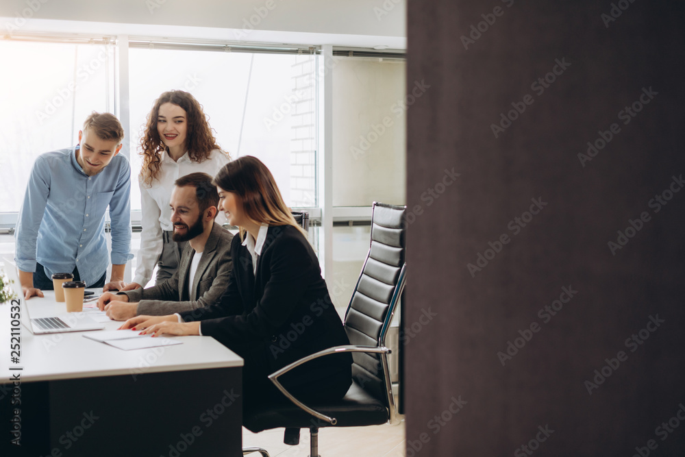 Young coworkers. Young modern colleagues in smart casual wear working while spending time in the office Young coworkers. Young modern colleagues in smart casual wear working while spending time in the office