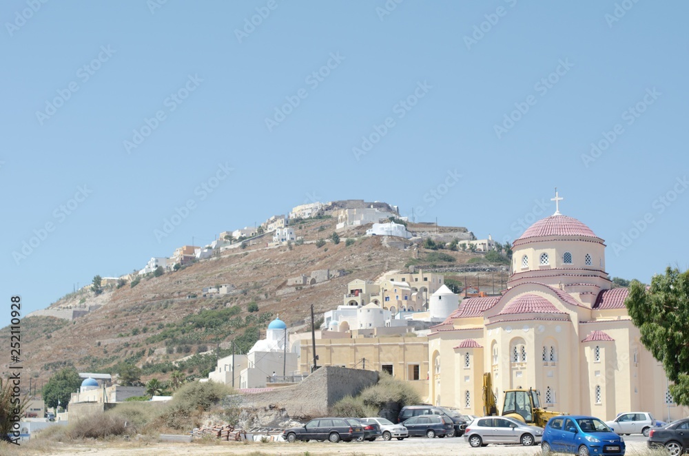 Church in front of a small hill in Santorini 