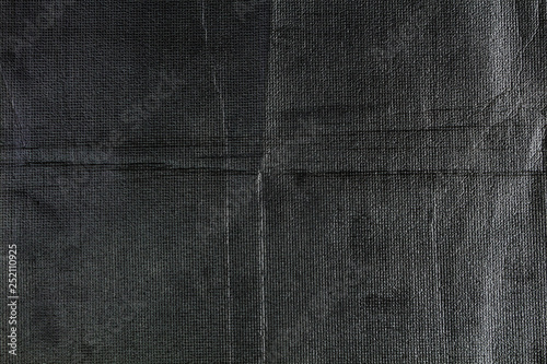 Black thin foam film closeup, texture background.