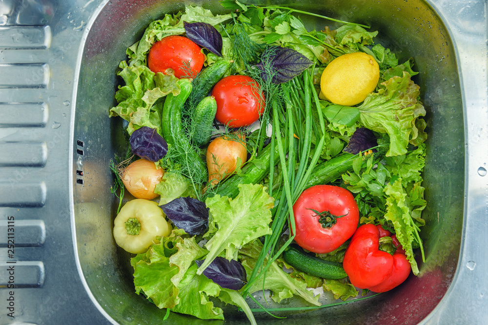 Wash vegetables before eating. Photo of vegetables in the sink. Delicious fresh vegetables close-up.