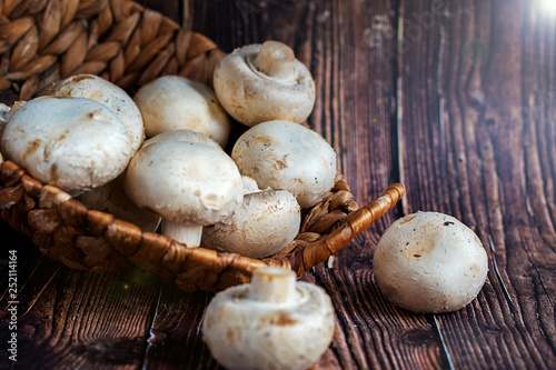 champignonsFresh mushrooms in a basket on a wooden background.