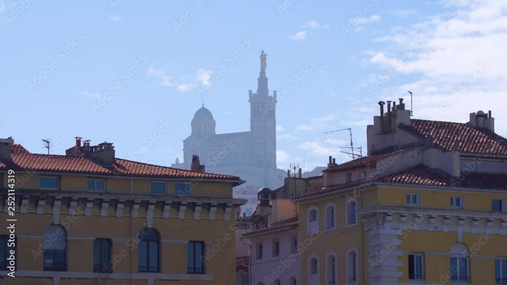 Red tiled roof Marseille houses and the Basilique Notre-Dame de la Garde in the foggy background, 4k Red tiled roof Marseille houses and the Basilique Notre-Dame de la Garde in the foggy background, 4k