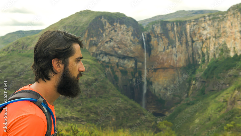 Naklejka premium Tourist walking along trails and photographing the Tabuleiro Waterfall 