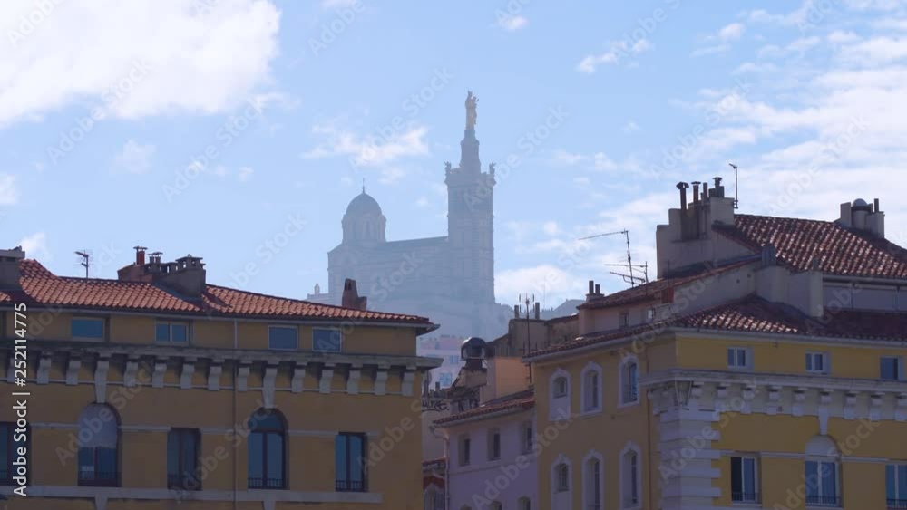 Red tiled roof Marseille houses and the Basilique Notre-Dame de la Garde in the foggy background, 4k Red tiled roof Marseille houses and the Basilique Notre-Dame de la Garde in the foggy background, 4k