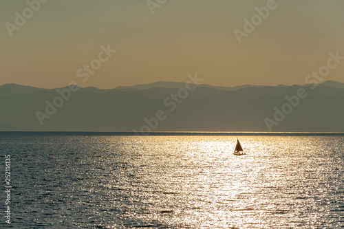 Golden sunrise over the sea. Solar reflections on the water's surface. © PhotoRK