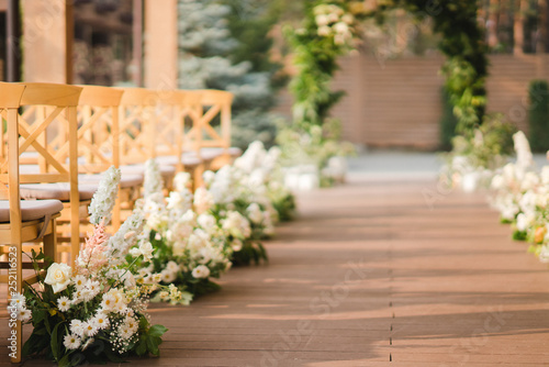 Coziness and style. Modern event design. Lounge zone and european traditional wedding ceremony decoration outdoors in the restaurant before the reception.