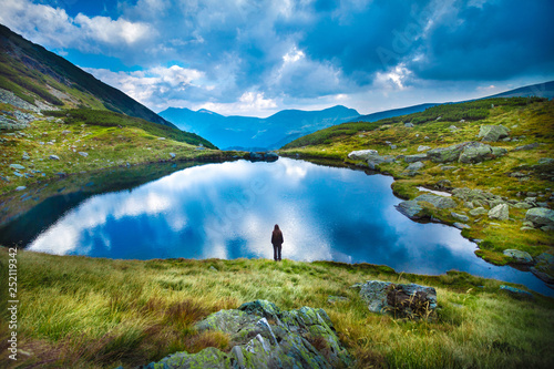 Girl admiring lake landscape view photo