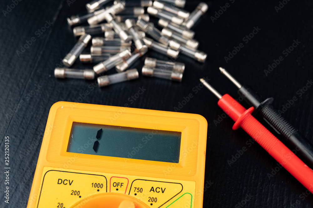 Checking glass fuses using the meter. Simple electrical work in a home workshop. Checking glass fuses using the meter. Simple electrical work in a home workshop.