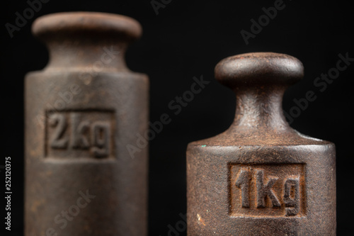 Old rusty metal weights for weighing products. Accessories for weight determination.