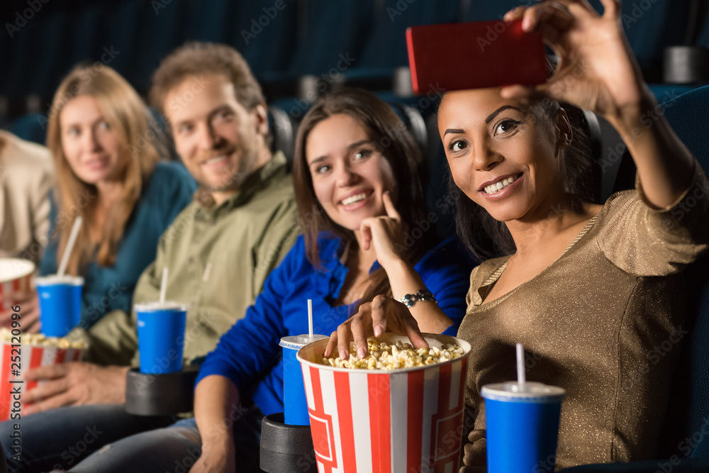 Group of friends making a selfie at the movie theatre