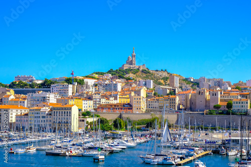 MARSEILLE, FRANCE - AUGUST 11, 2018 - Marseille embankment with yachts and boats in the Old Port and Notre Dame de la Garde. Vieux-Port de Marseille. photo
