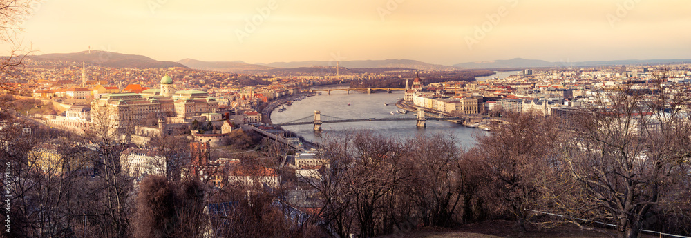 Panorama image of Budapest with Buda castle, Chain bridge and Parliament building during sunset