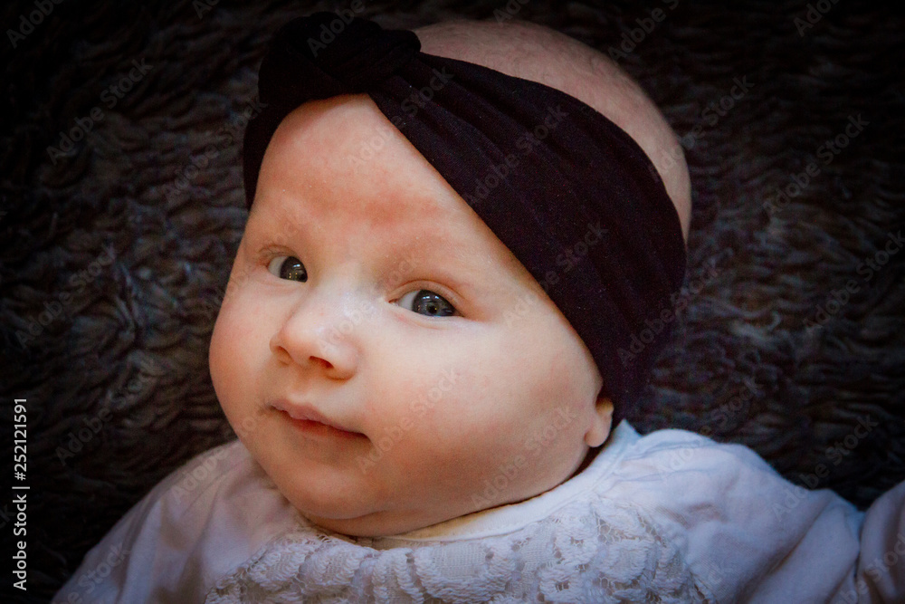 baby girl portrait on grey blanket baby girl portrait on grey blanket