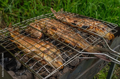Roasted on grill fresh fish. Carp baked on BBQ