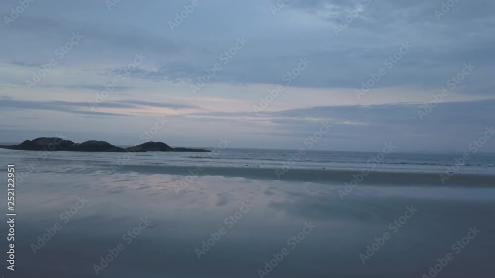 Aerial seascape view of the Pacific Ocean Coast during a cloudy summer sunset. Taken near Tofino and Ucluelet, Vancouver Island, BC, Canada. Aerial seascape view of the Pacific Ocean Coast during a cloudy summer sunset. Taken near Tofino and Ucluelet, Vancouver Island, BC, Canada.