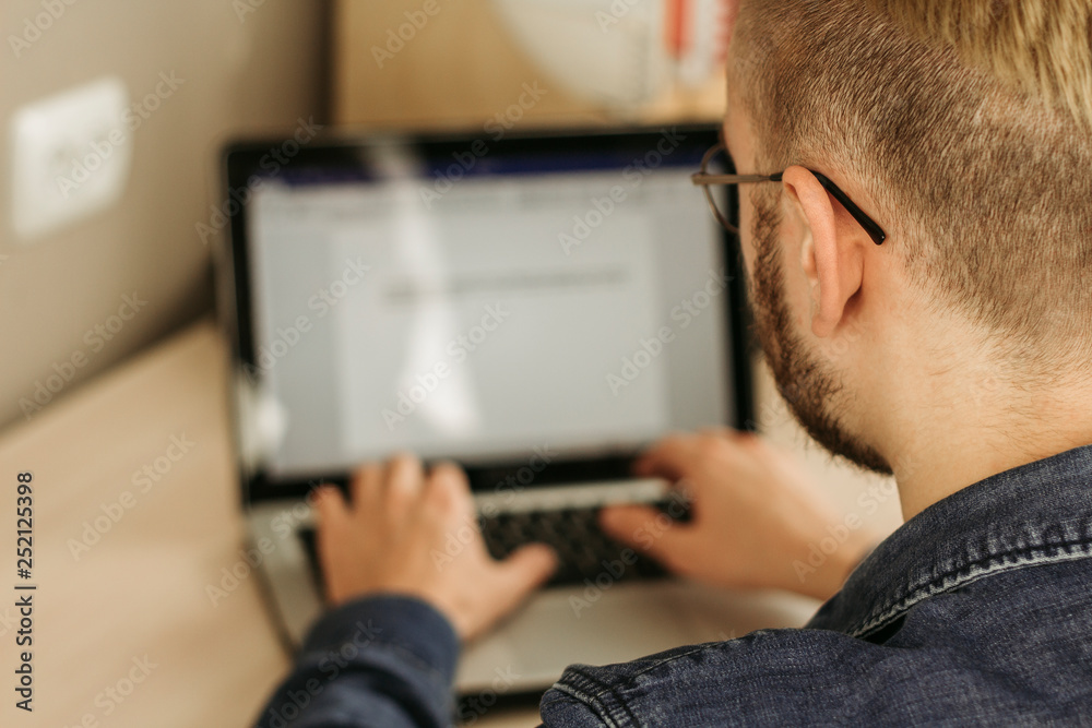 Unrecognizable man working on business project via internet while working remotely from home Unrecognizable man working on business project via internet while working remotely from home