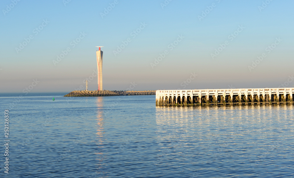 Lighthouse and pier in Ostend, Belgium on a sunny winter evening