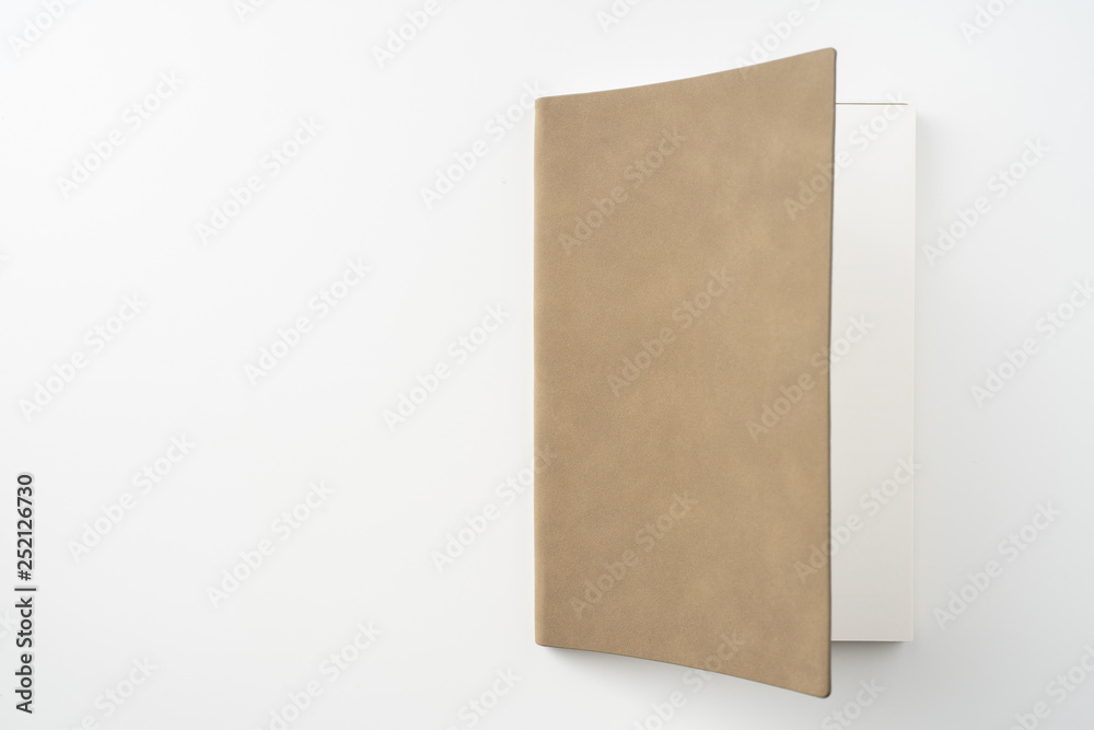 opened brown notebook on white background opened brown notebook on white background