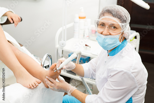 Professional pedicurist working at the salon