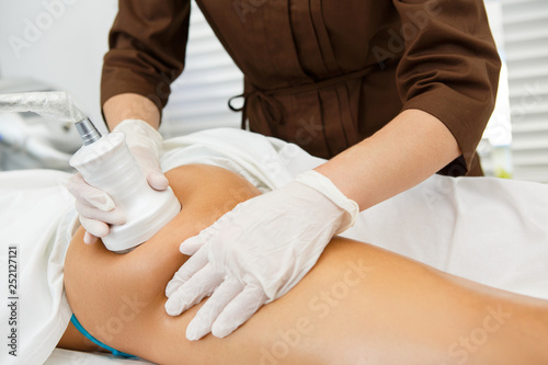 Beautiful woman receiving vacuum massage at the salon photo