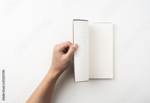 Fototapeta Naklejka Na Ścianę i Meble -  man hand hold brown notebook on white background