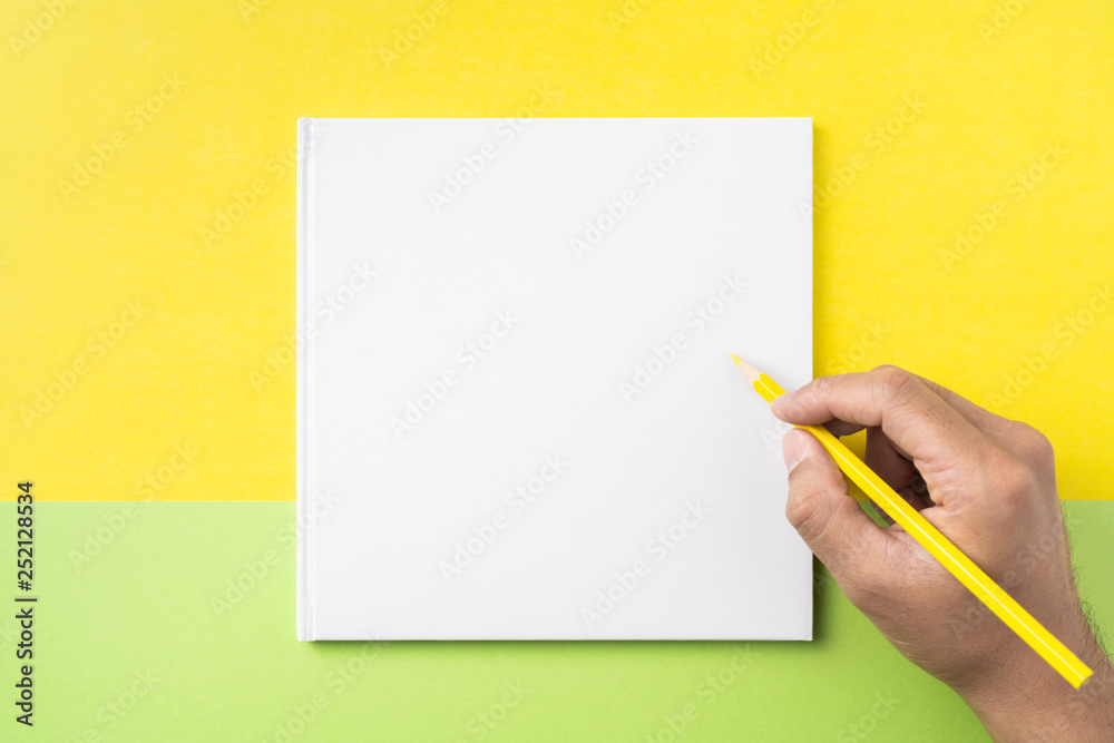 man's hand hold pen and white square notebook man's hand hold pen and white square notebook