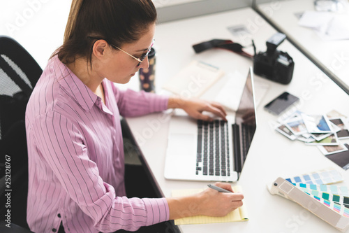 Designer working in office, using laptop