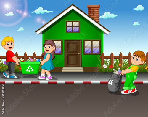 Volunteer kids collecting trash at street of house