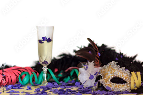 Carnival Mask, Serpentines, Confetti and glass of champagne. Colorful party background with copy space