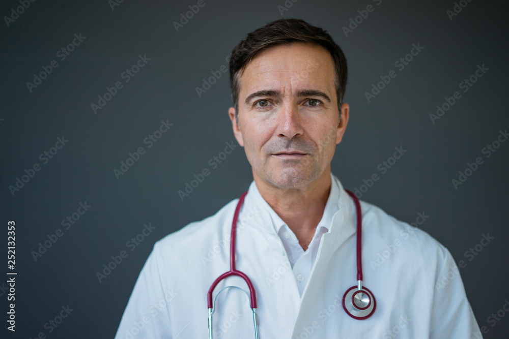Portrait of doctor at a grey wall Portrait of doctor at a grey wall