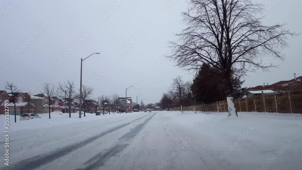 Driving Bumpy Snowy Street in Day. Driver Point of View POV Winter Driving While Snowing in Daytime. Driving Bumpy Snowy Street in Day. Driver Point of View POV Winter Driving While Snowing in Daytime.