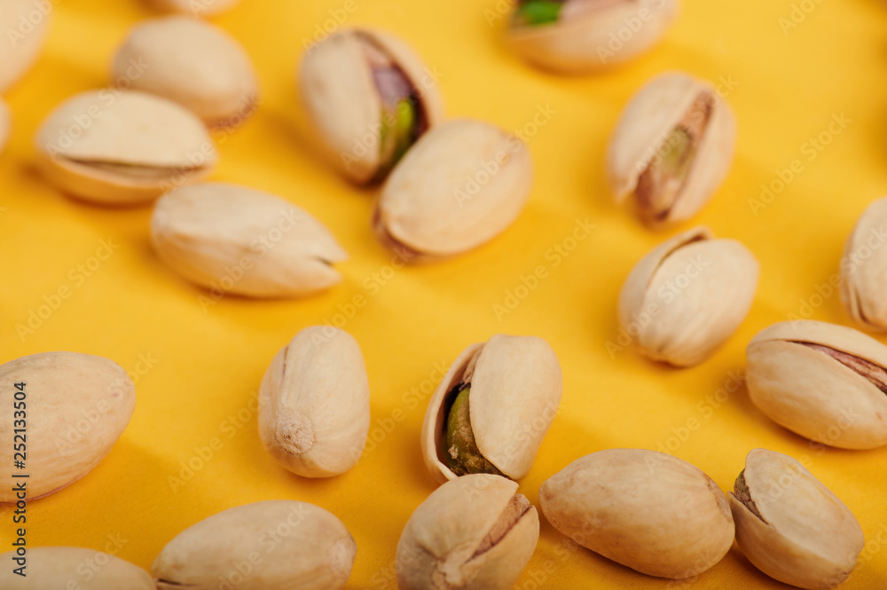 Group of pistachio on yellow background