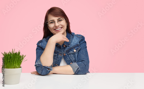 Happy overweight woman at white table  photo