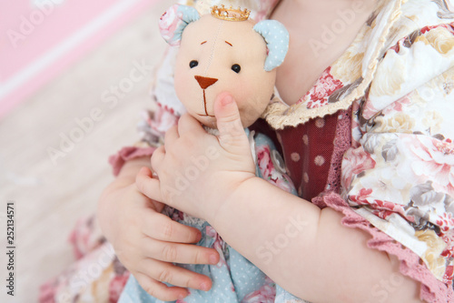 the hands hold the bear toy photo