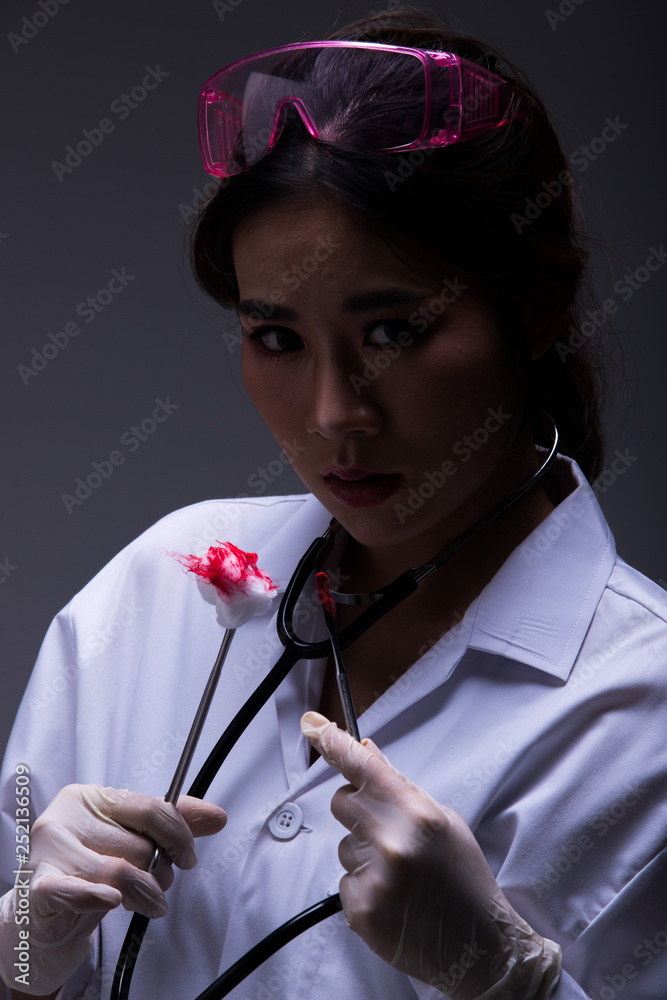 Asian Beautiful Doctor Nurse woman in uniform with stethoscope, rubber  gloves, protective glasses in Medical hospital, holding blood wound  bandage, studio lighting dark gray background low exposure Stock Photo |  Adobe Stock