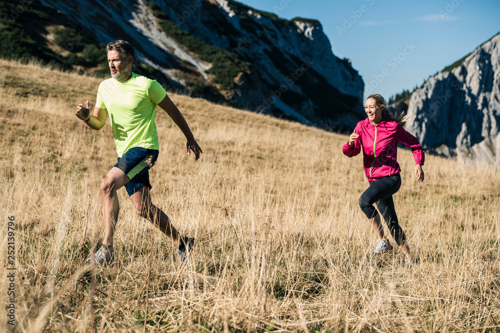 Austria, Tyrol, couple running in the mountains
