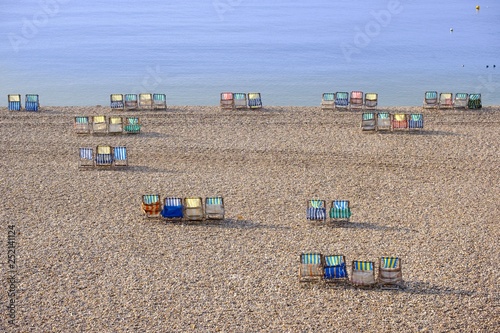Colorful canvas chairs at the shingle beach, Beer, Jurassic Coast, Devon, England, United Kingdom, Europe